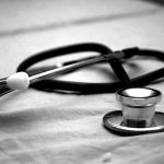 A close-up of a stethoscope on a medical examination table